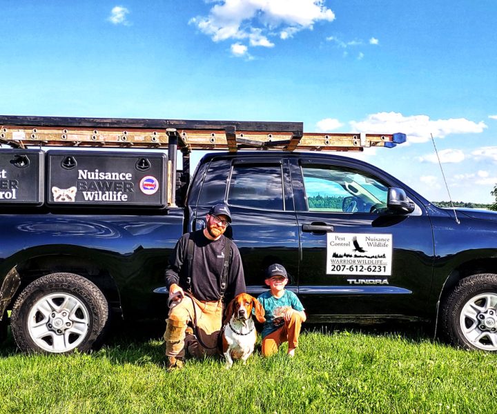 Jesse Huff with his dog and pest control truck, ready for a day's work.